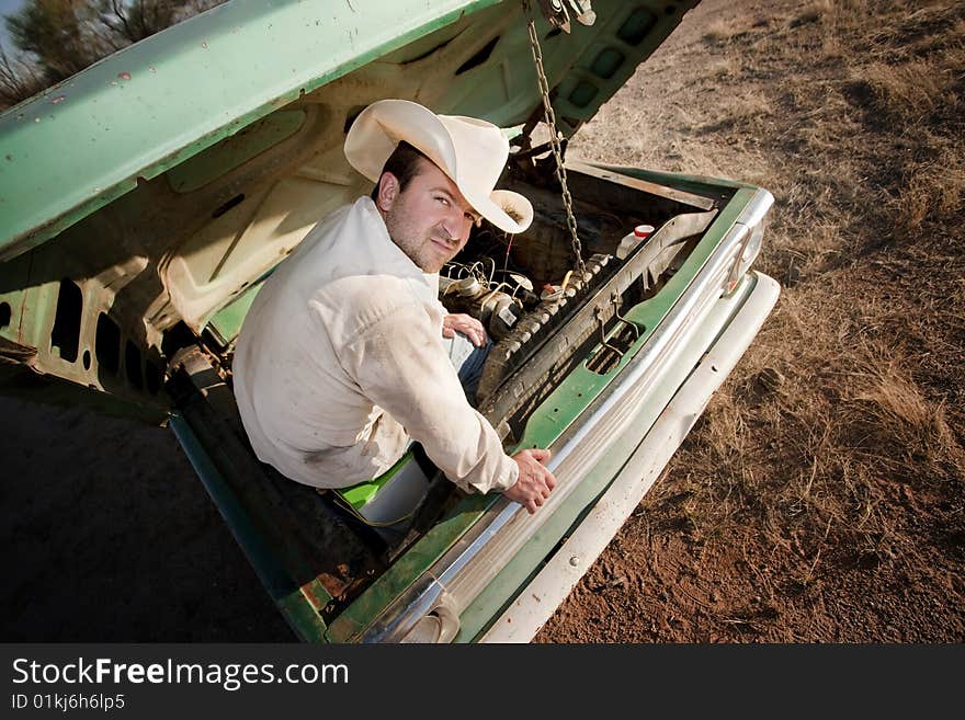 Man under the hood of his truck