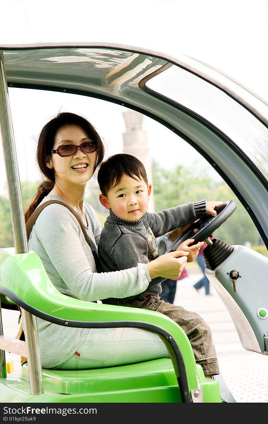 Boy and mother driving electromobile