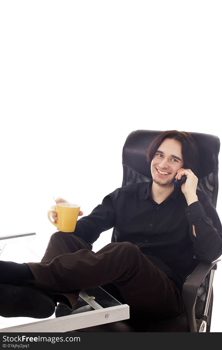 A young business man having a break in his office. A young business man having a break in his office