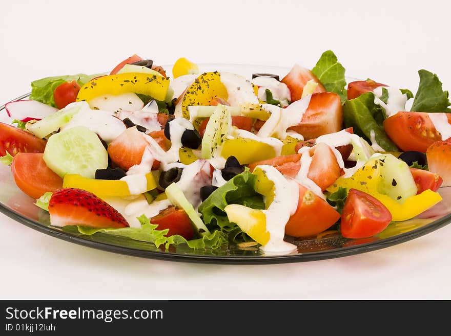 Fresh vegetables salad with creamy dip on a white background. Fresh vegetables salad with creamy dip on a white background