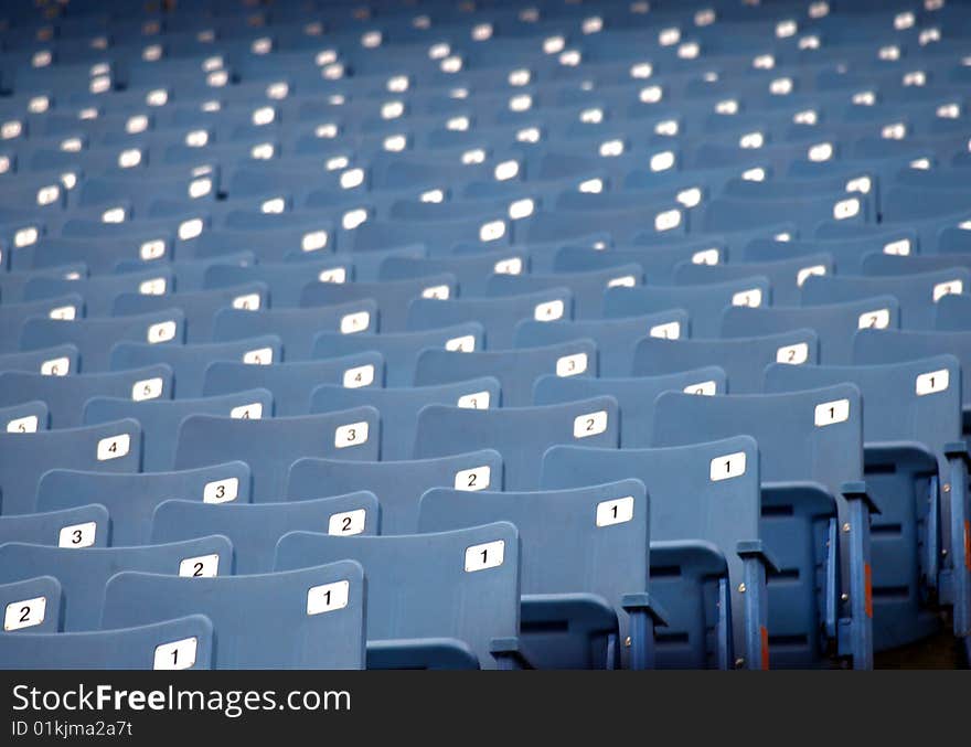 Row of blue empty seats at a sports arena. Row of blue empty seats at a sports arena