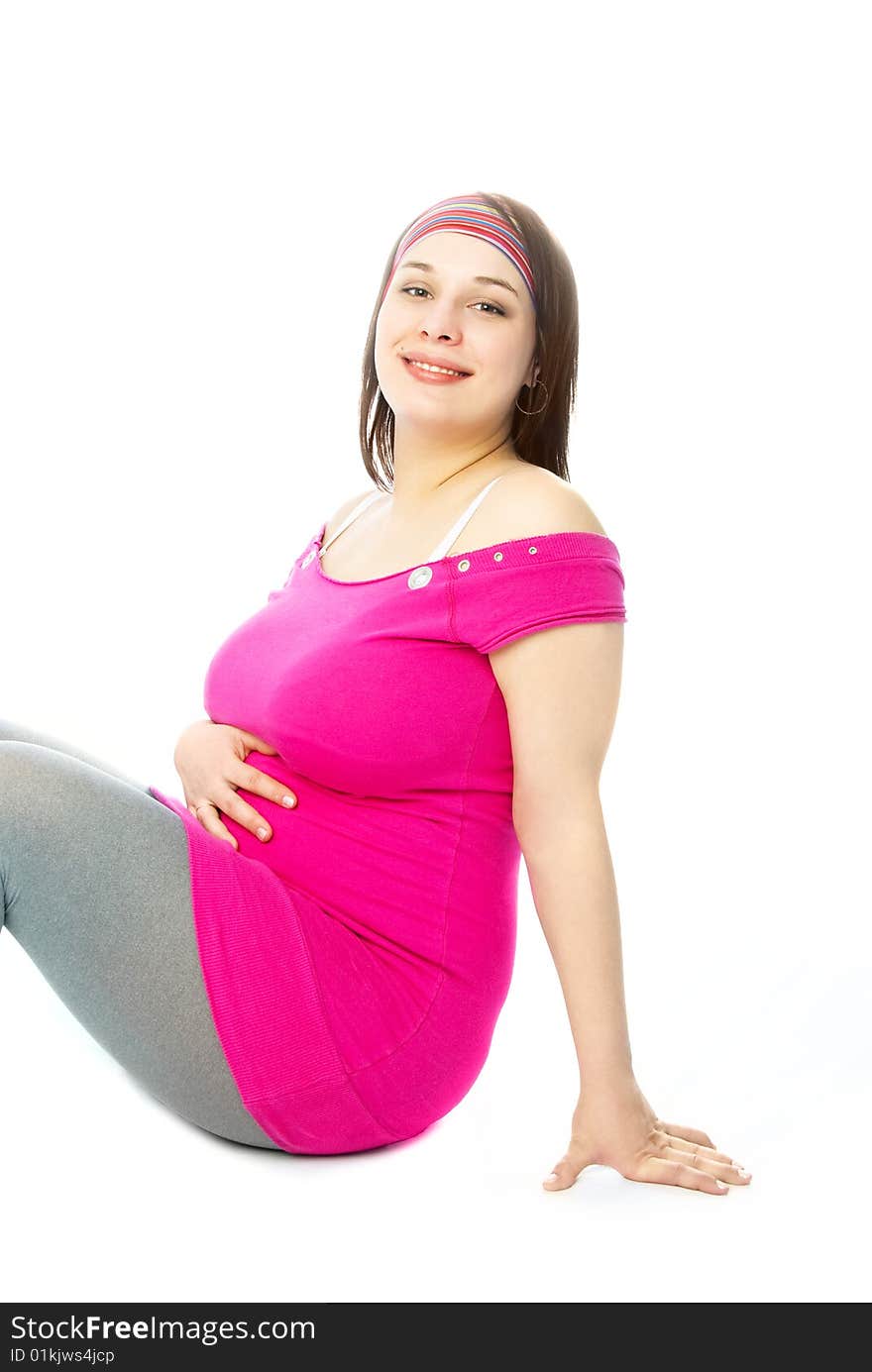 Portrait of a happy beautiful pregnant woman sitting on the floor. Portrait of a happy beautiful pregnant woman sitting on the floor