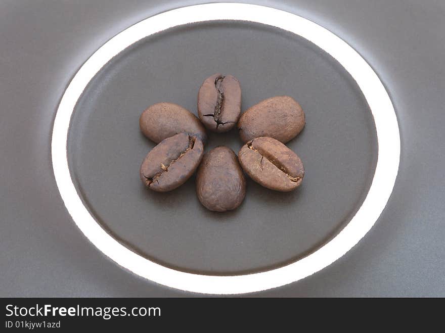 Coffee beans on the brown backgound