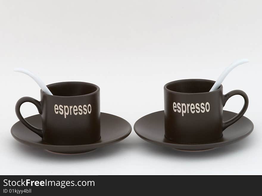 Two coffee cups with white tea-spoons