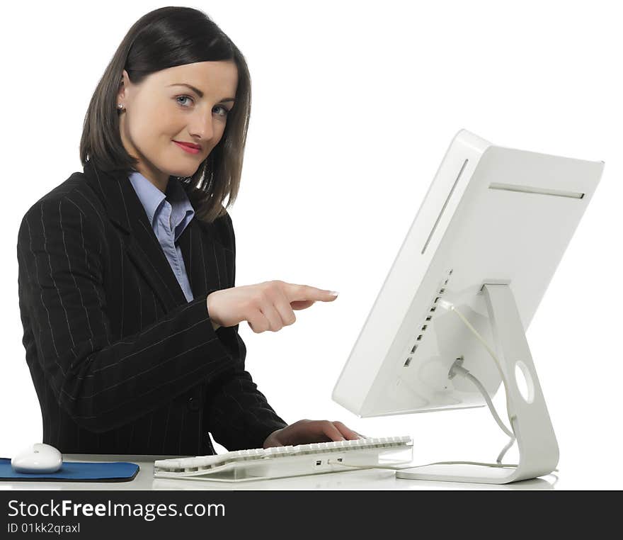 Beautiful businesswoman in her office indicating something on laptop