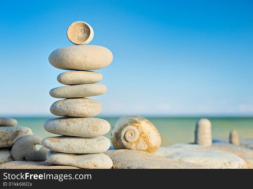 Several cobble-stones in tandem of pyramid on the shore. Several cobble-stones in tandem of pyramid on the shore