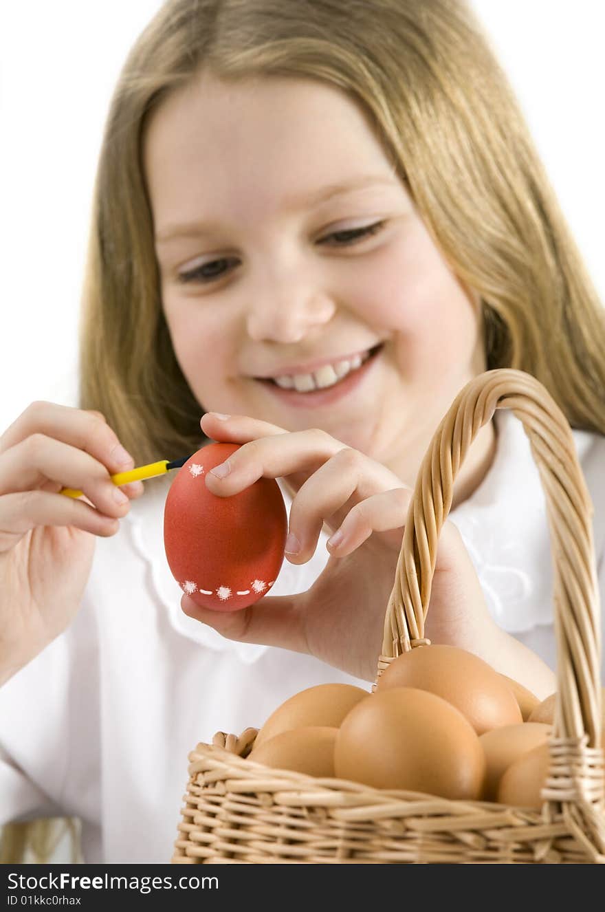 Cute little girl painting easter eggs