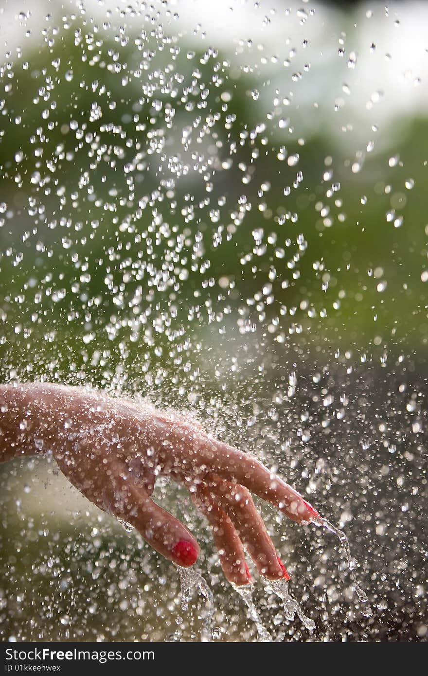 Fresh water falling on a women's hands. Fresh water falling on a women's hands