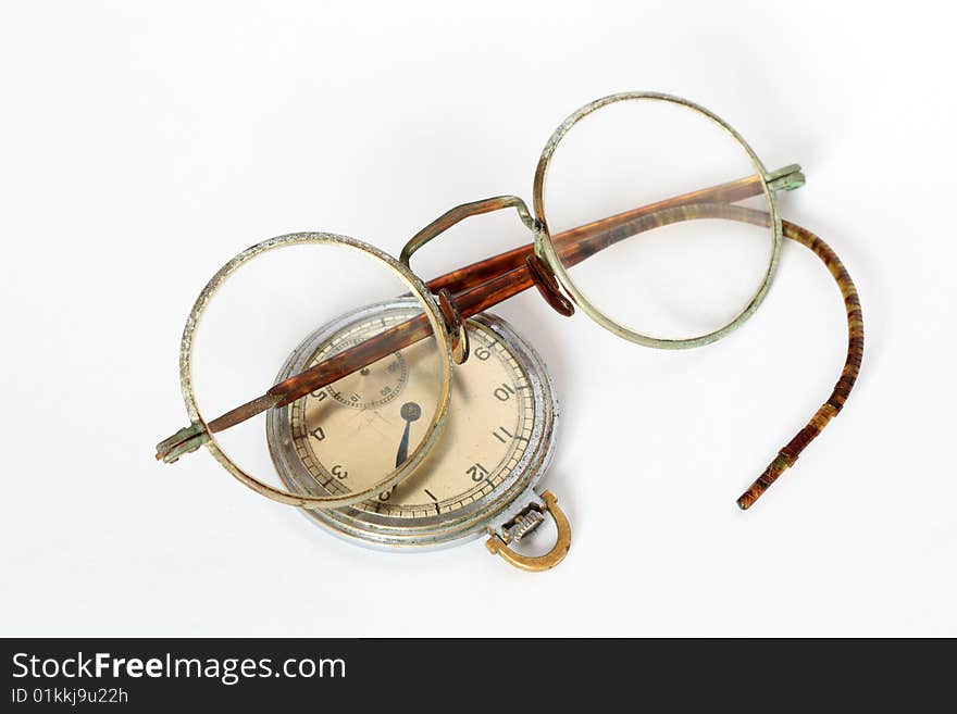 Vintage spectacles and watch lying on white background. Vintage spectacles and watch lying on white background