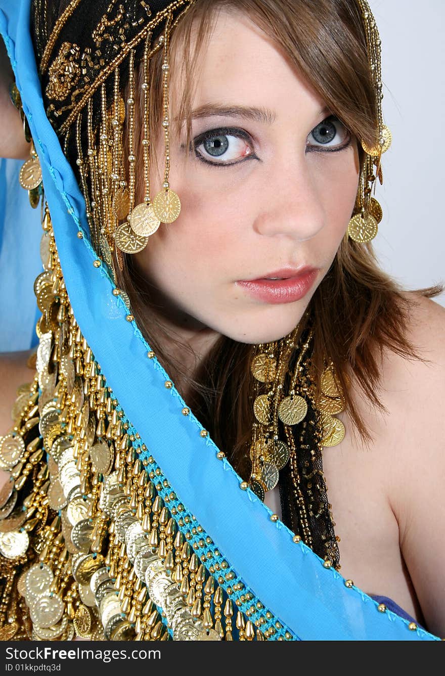 Beautiful young teenager posing in a belly dance costume. Beautiful young teenager posing in a belly dance costume