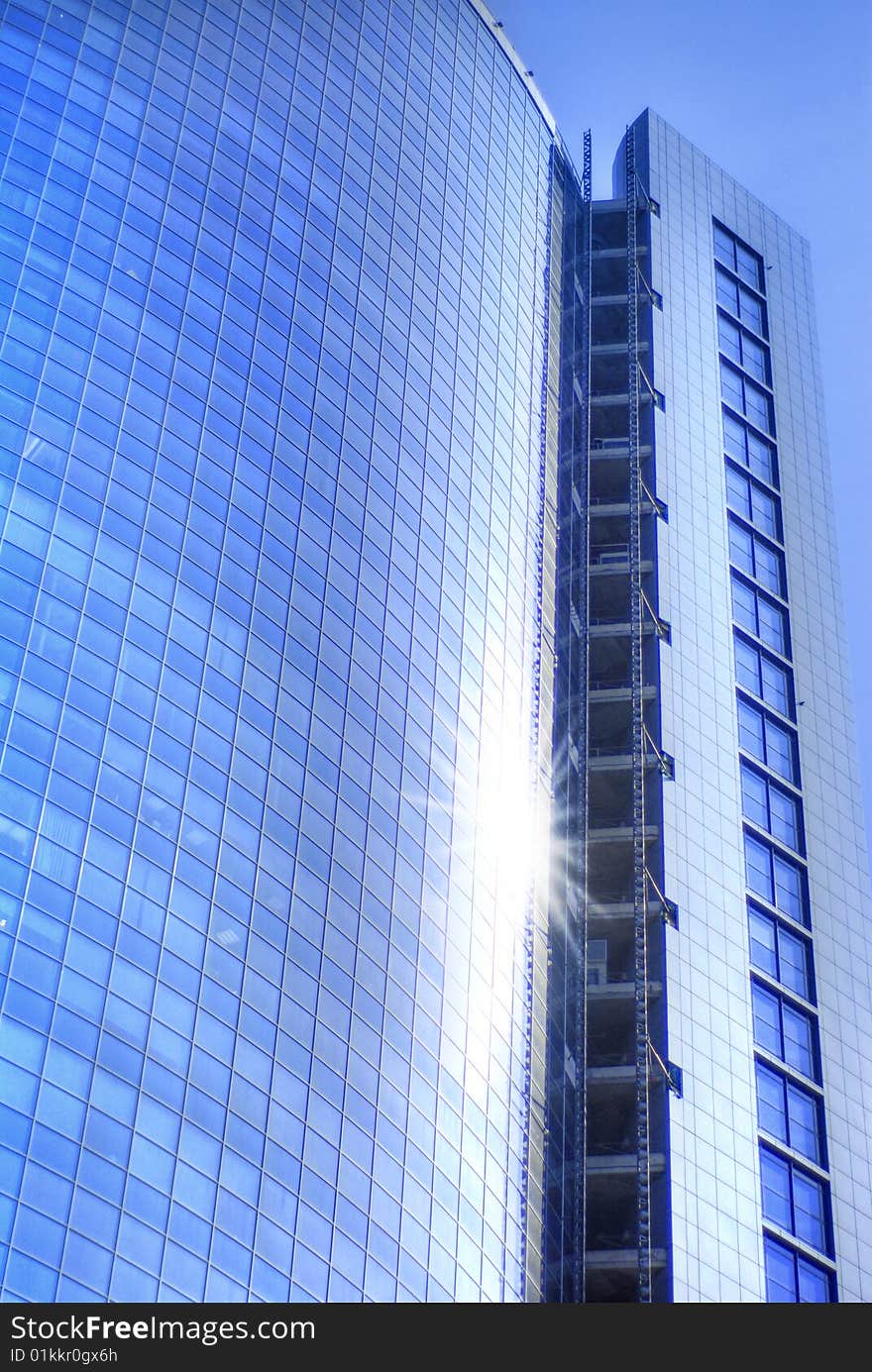 Modern skyscrapers close-up toned in blue color. Modern skyscrapers close-up toned in blue color