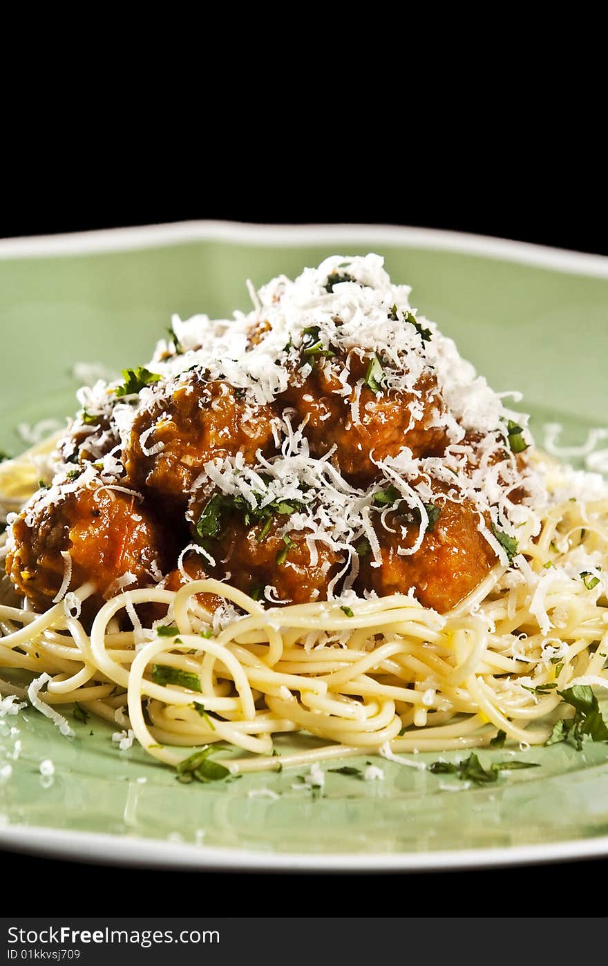 Spaghetti and meat balls with tomato sauce garnished with basil. Spaghetti and meat balls with tomato sauce garnished with basil