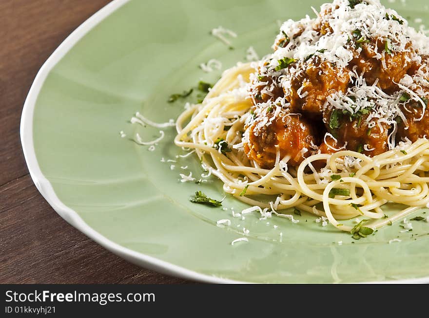 Spaghetti and meat balls with tomato sauce garnished with basil. Spaghetti and meat balls with tomato sauce garnished with basil