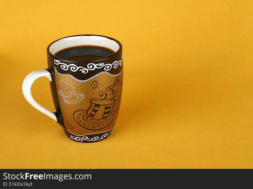 Coffee cup on a yellow background with an empty seat for the signature