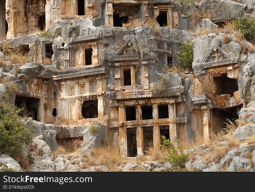 Tombs carved into the side of a cliff, overlooking the ruins of the ancient city of Myra, Turkey. Tombs carved into the side of a cliff, overlooking the ruins of the ancient city of Myra, Turkey