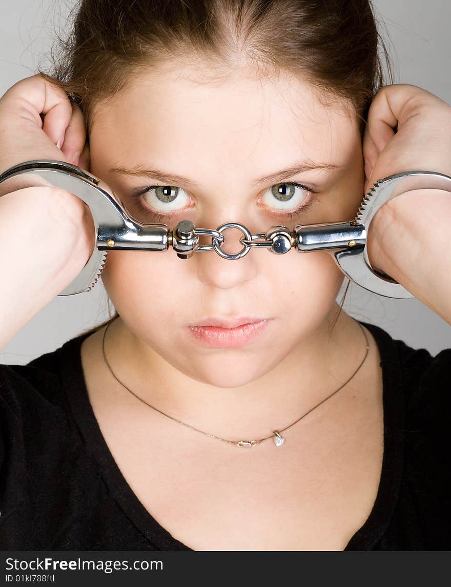 Young beautiful woman with hands in handcuffs. Young beautiful woman with hands in handcuffs