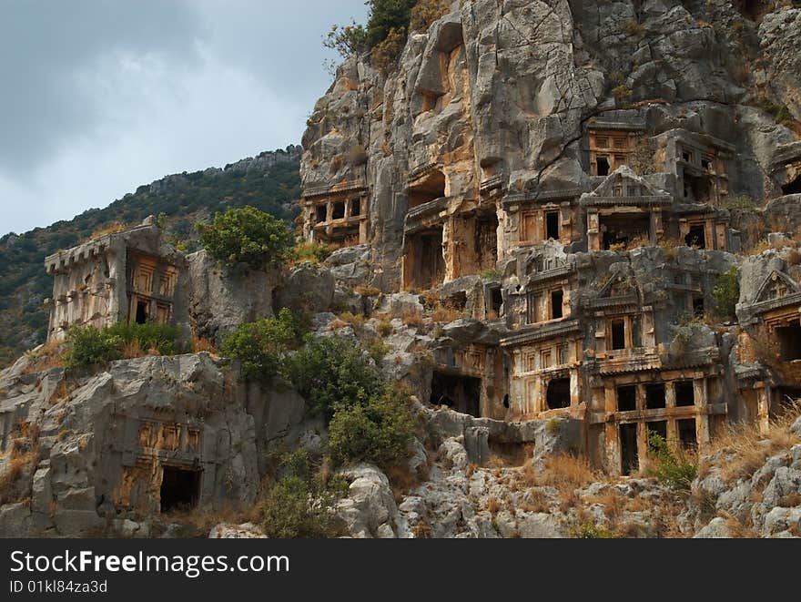 Tombs carved into the side of a cliff, overlooking the ruins of the ancient city of Myra, Turkey. Tombs carved into the side of a cliff, overlooking the ruins of the ancient city of Myra, Turkey