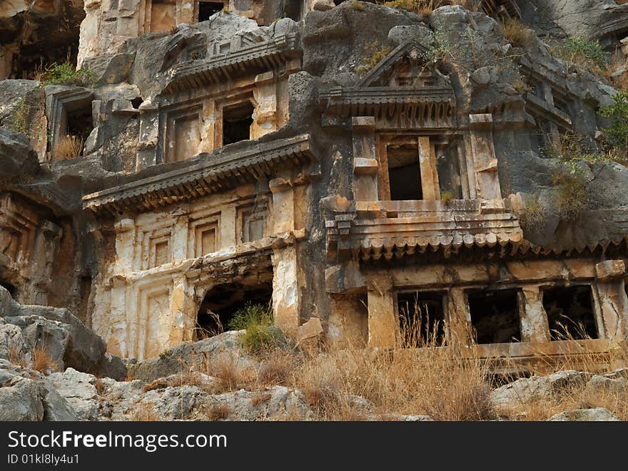 Tombs carved into the side of a cliff, overlooking the ruins of the ancient city of Myra, Turkey. Tombs carved into the side of a cliff, overlooking the ruins of the ancient city of Myra, Turkey