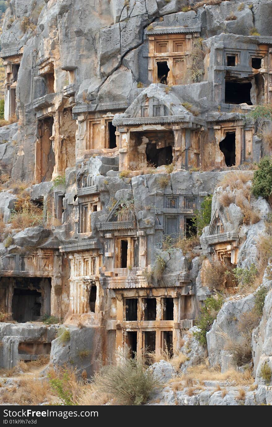 Tombs carved into the side of a cliff, overlooking the ruins of the ancient city of Myra, Turkey. Tombs carved into the side of a cliff, overlooking the ruins of the ancient city of Myra, Turkey