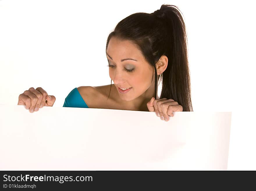 Young caucasian brunette holding a blank panel with surprised facial expression isolated on white,wearing casual clothes.Concept of advertising. Young caucasian brunette holding a blank panel with surprised facial expression isolated on white,wearing casual clothes.Concept of advertising