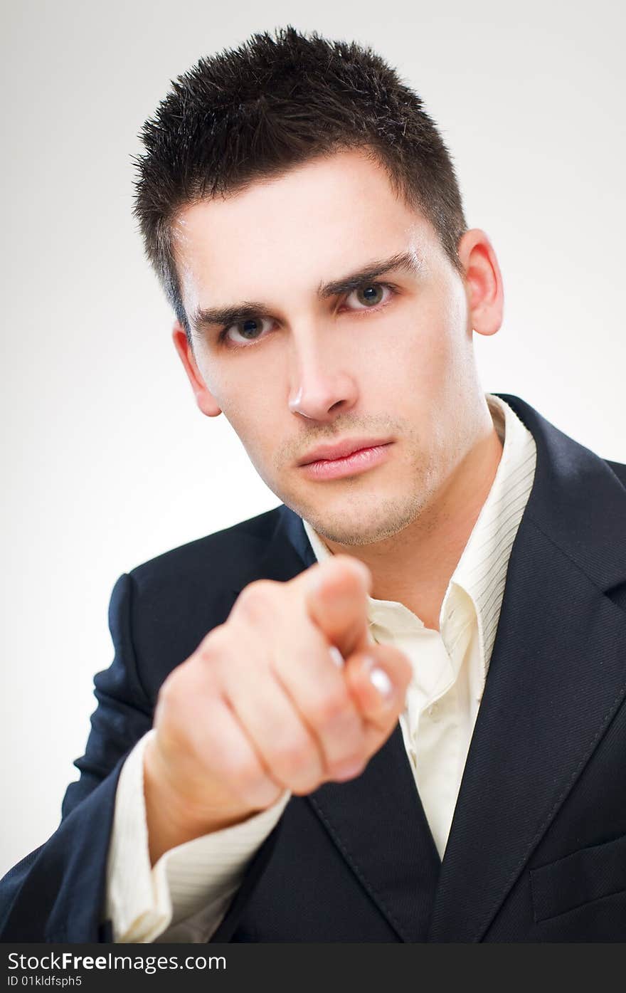 Young business man pointing accusing finger close up