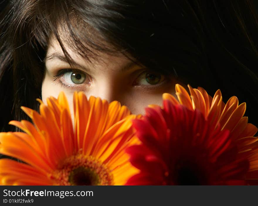 Young beautiful brunette woman's portrait with flowers