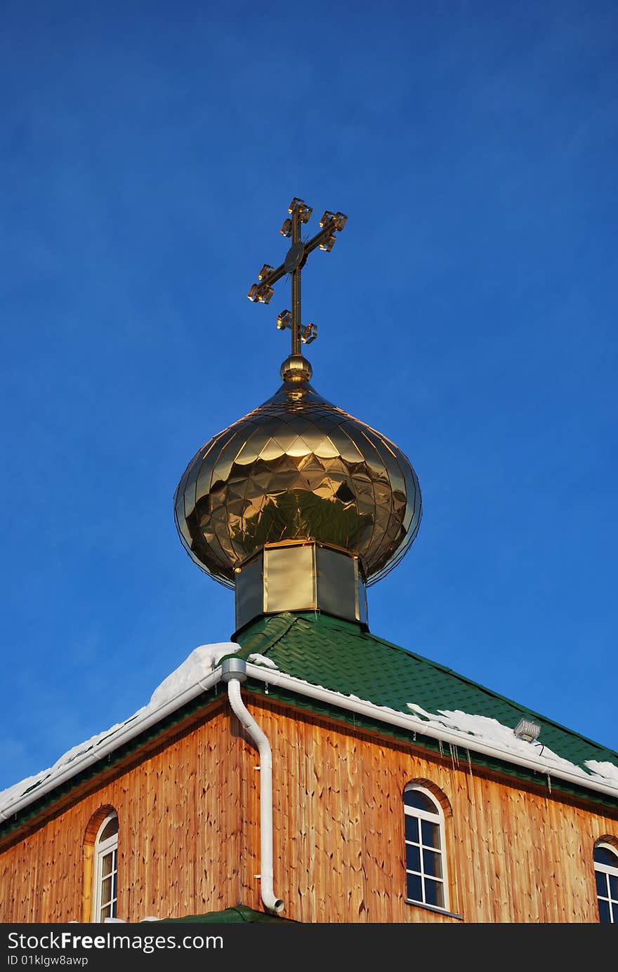 Cross of orthodox church against blue sky