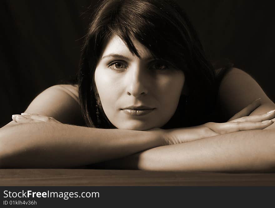 Portrait of young woman on black background