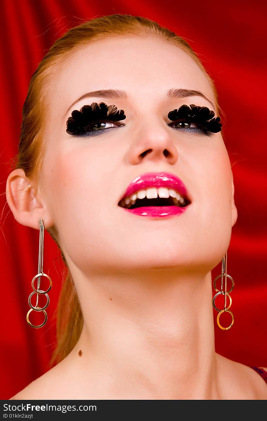 Glamour portrait of lovely blond young woman with big eyelashes