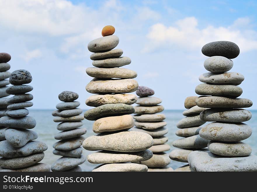 Several different high pyramids of marine gravel. Several different high pyramids of marine gravel