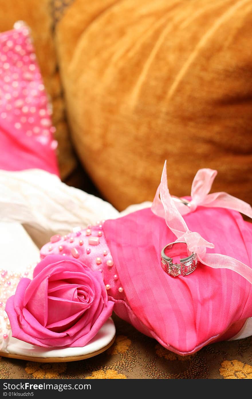 Wedding shoes and cushion with rings and rose