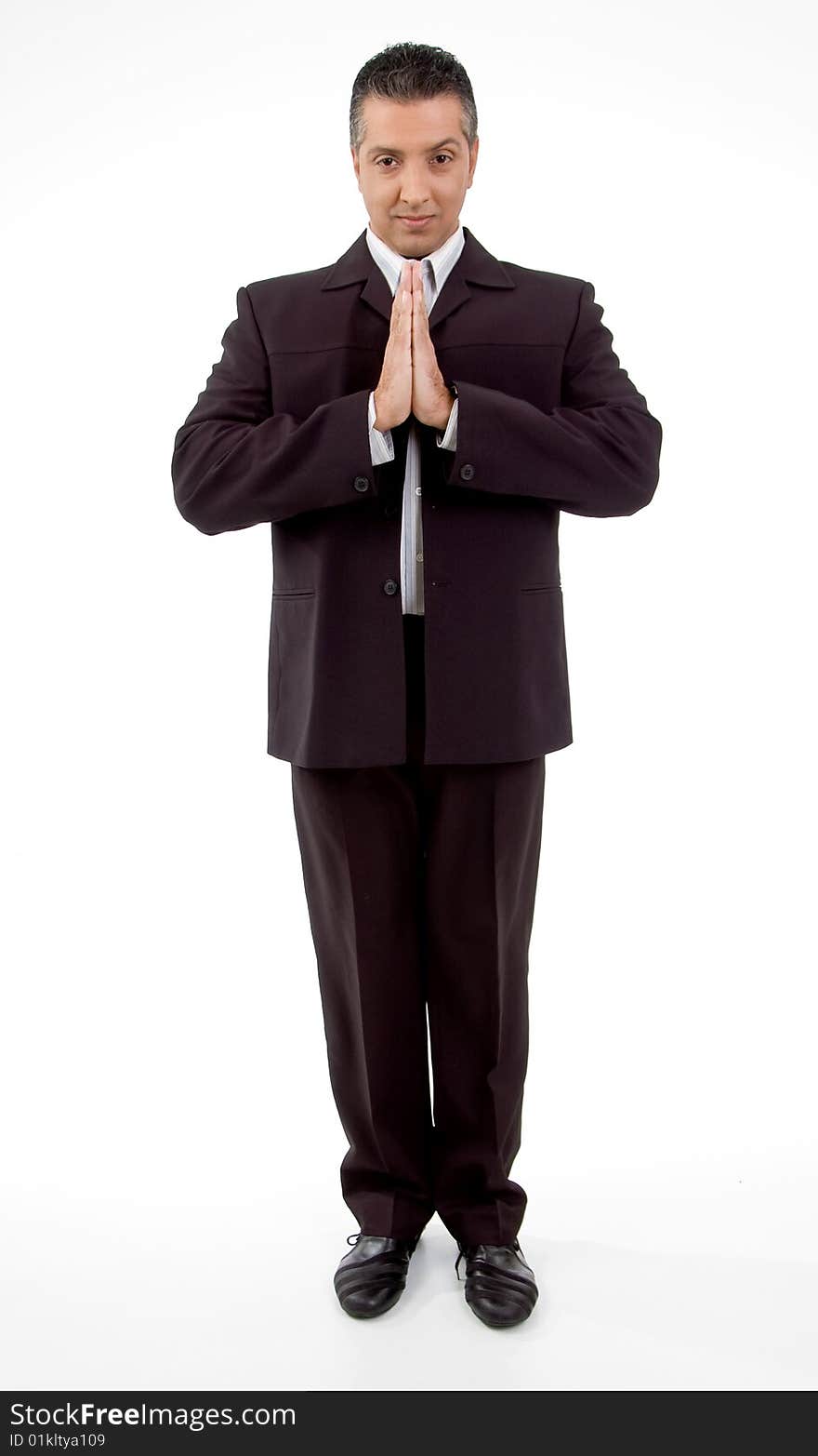 Front view of praying adult businessman with white background