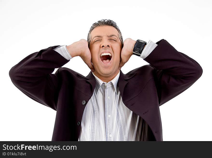 Front view of shouting businessman putting hands on his ears with white background