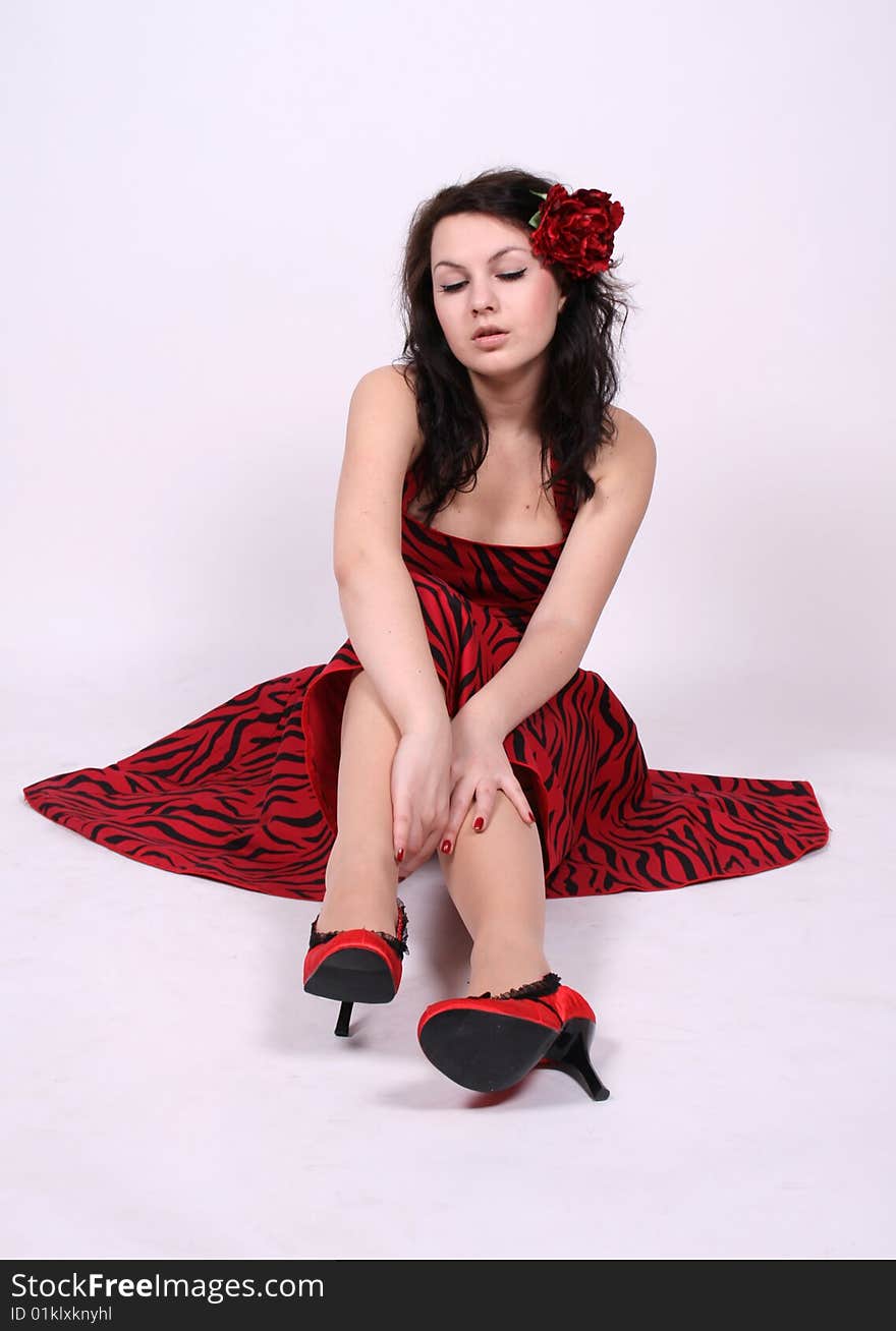 Pretty pinup girl sitting in studio