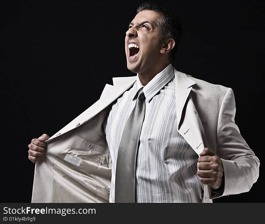 Side view of aggressive businessman holding coat