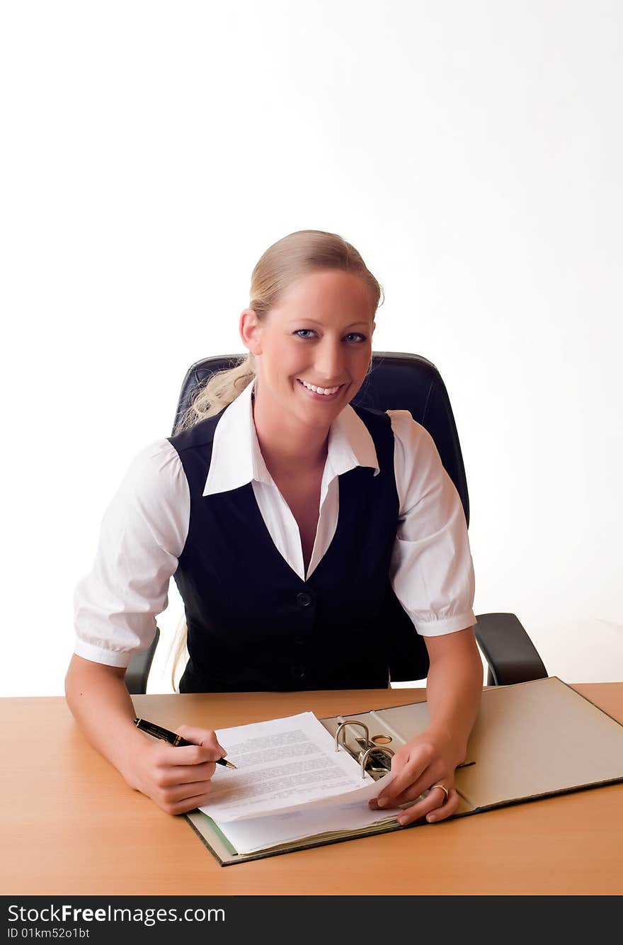 Young Woman Is Working With A Folder At The Desk