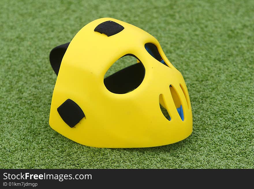 Field hockey equipment on green grass