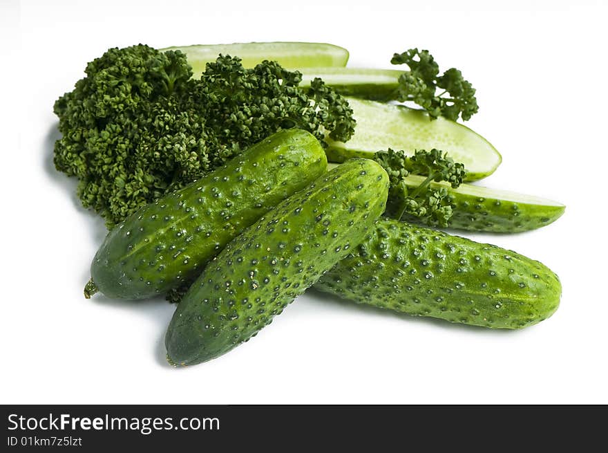 Cutted and whole cucumbers and parsley