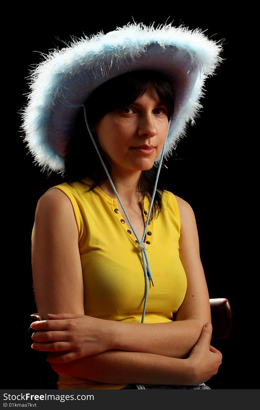 Brunette girl with cowboy hat, isolated on black