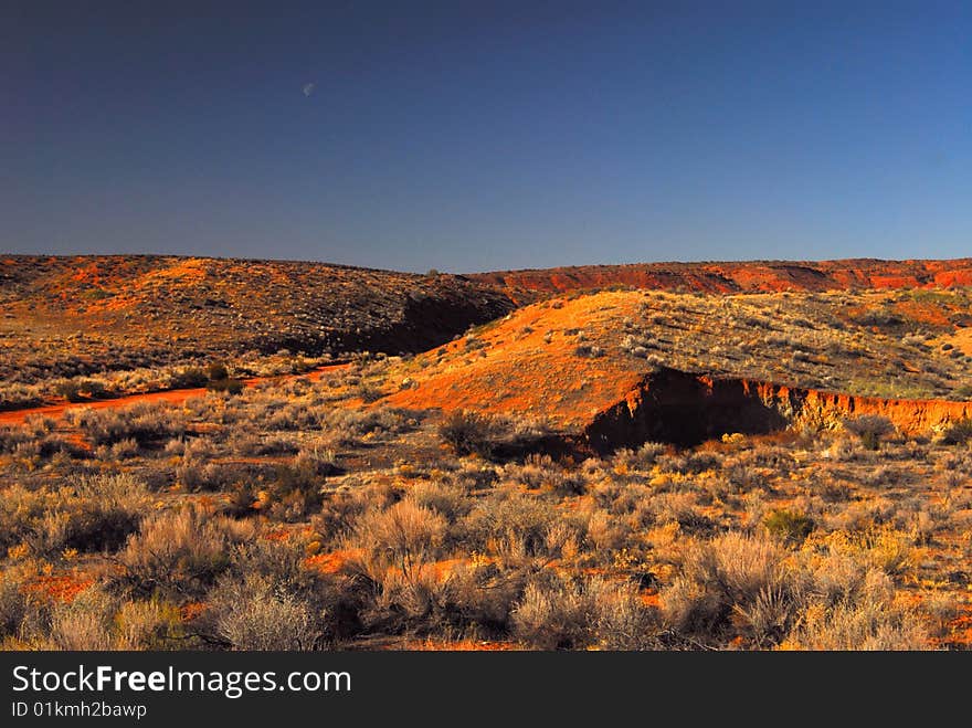 High desert landscape and moon in Arches