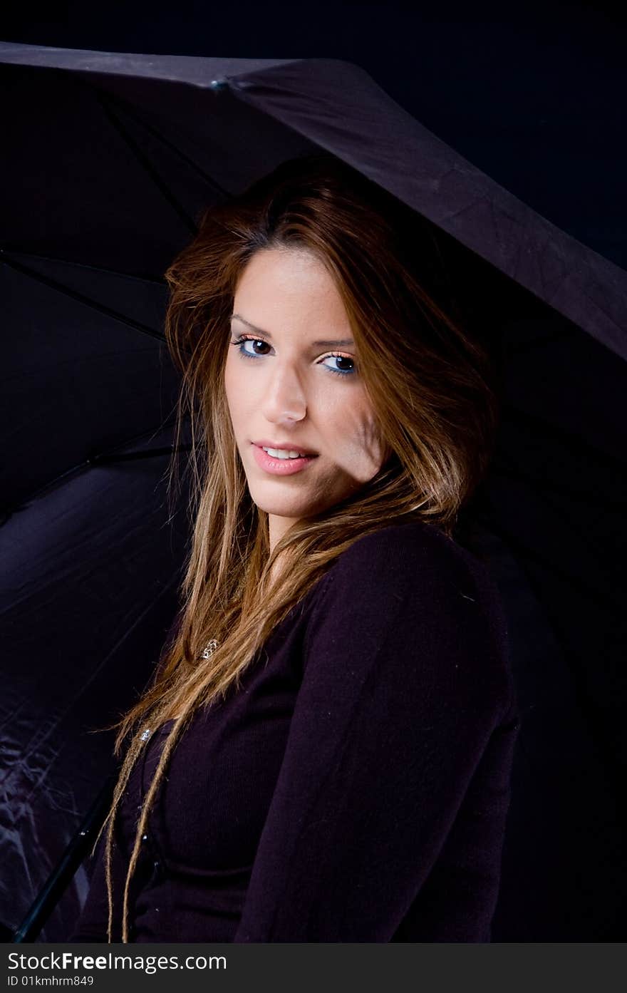 Portrait of smiling woman holding umbrella