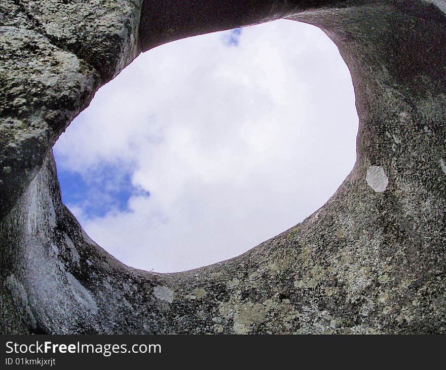 Sky view through granite rock weathered by time. Sky view through granite rock weathered by time