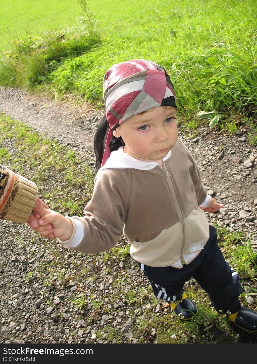 Little boy hand in hand with mother