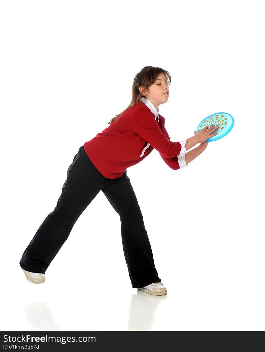 An elementary girl catching a blue frisbee.  Isolated on white. An elementary girl catching a blue frisbee.  Isolated on white.