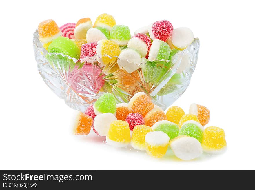 Heap fruit candy in cut glass dish; isolated on white