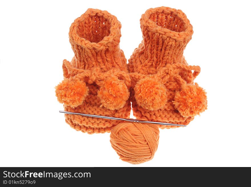 Close up look on woollen baby shoes isolated in white.