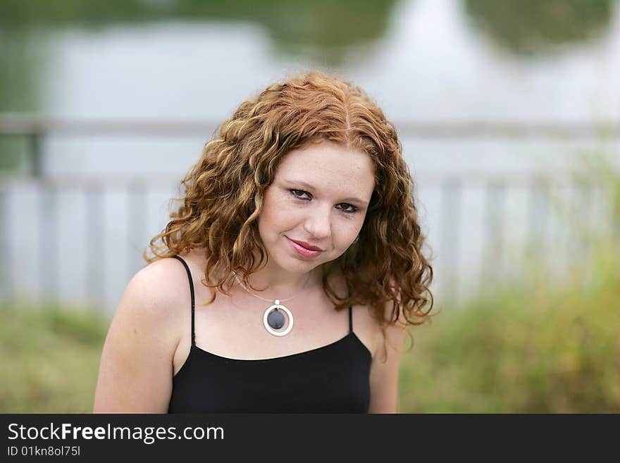 Headshot portrait of one thin redhead woman outdoors. Headshot portrait of one thin redhead woman outdoors