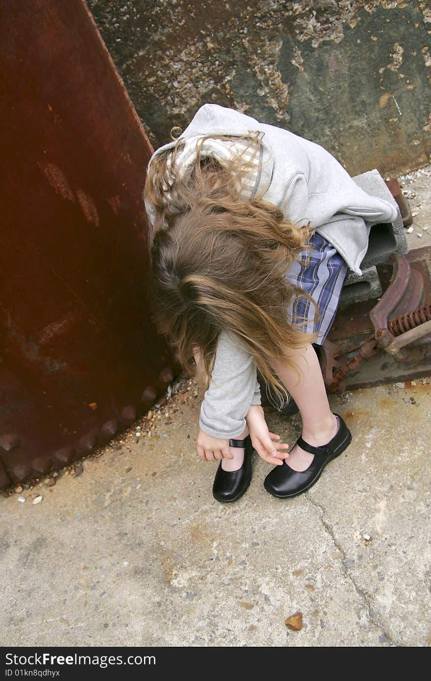 One sad looking young female holding her head and covering face. One sad looking young female holding her head and covering face