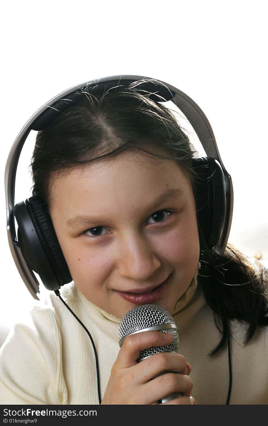 Young girl with microphone singing a song. Young girl with microphone singing a song