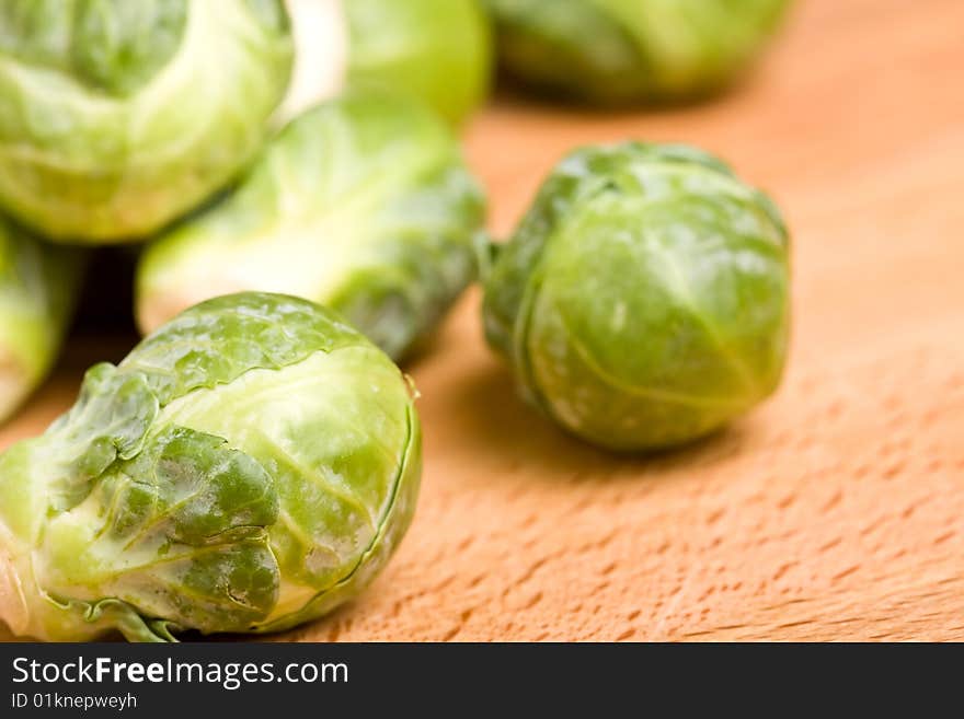 Close up of brussel sprouts on a wood cutting block. Close up of brussel sprouts on a wood cutting block